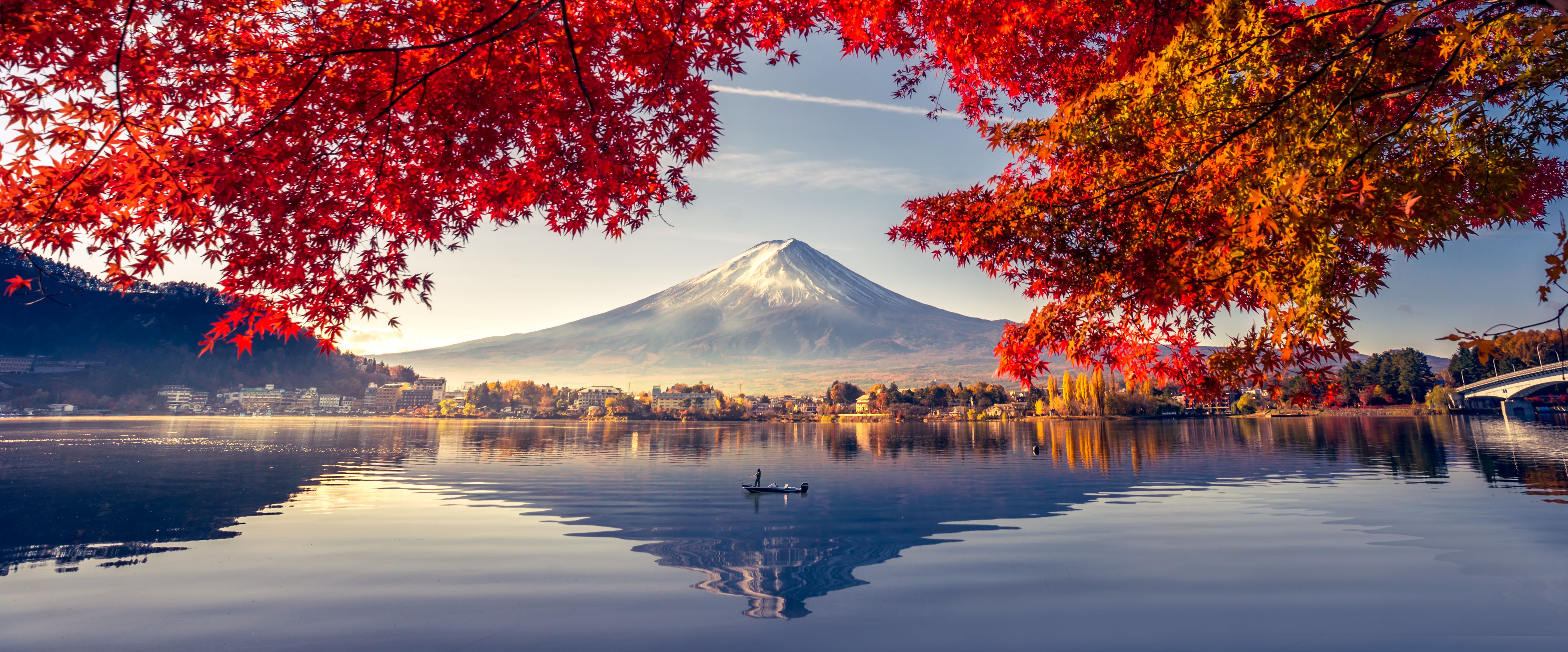 Mount Fuji with autumn maple leaves and lake reflection in Japan
