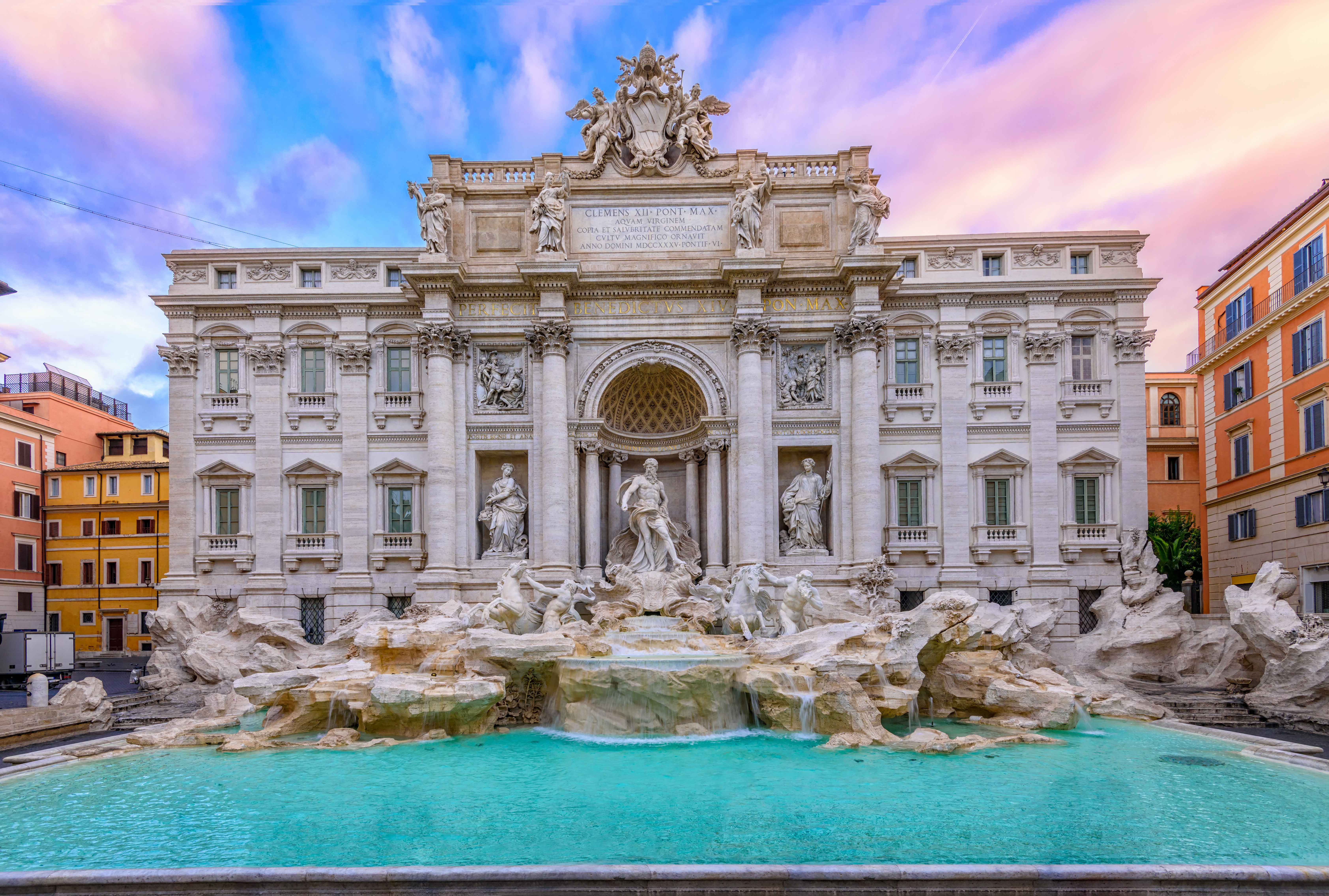 Rome's iconic Trevi Fountain at sunset with baroque architecture