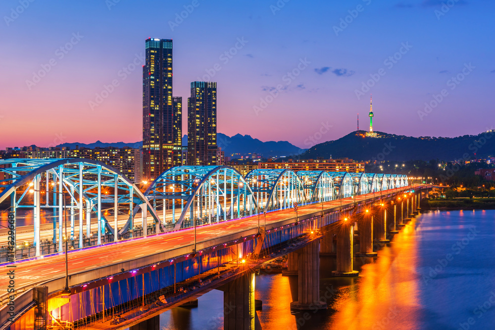 Night view of a lit bridge over the Han River in Seoul